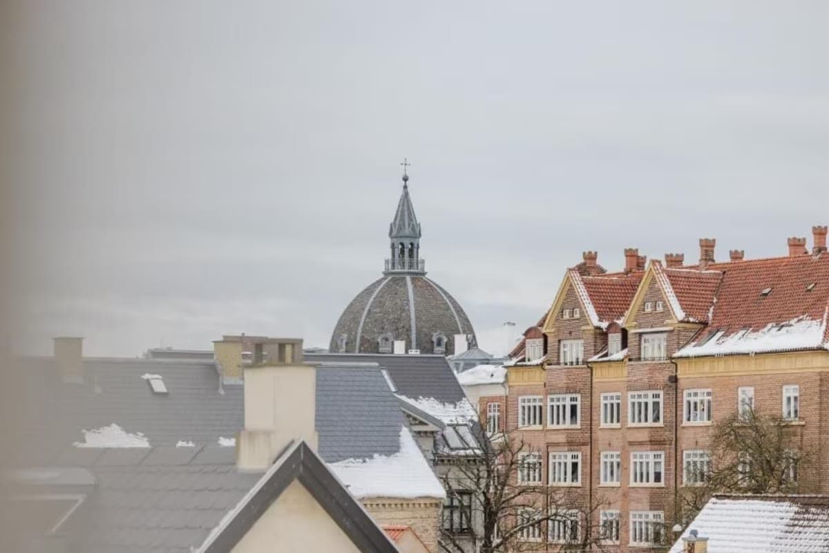 Domed church roof and city rooftops viewed from indoors