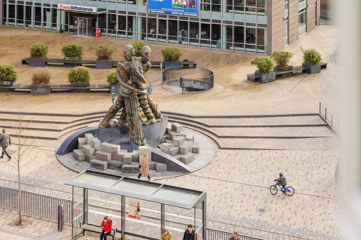 Odense square with sculpture and bus stop seen from above